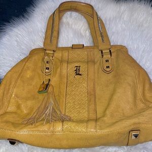 L.A.M.B. By Gwen Stefani.  Yellow or mustard colored lamb skin leather satchel.